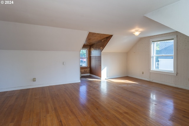 bonus room with hardwood / wood-style flooring and lofted ceiling