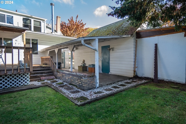 back of property featuring a patio area and a lawn