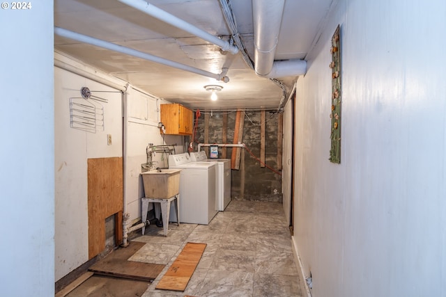 clothes washing area with cabinets and washer and dryer