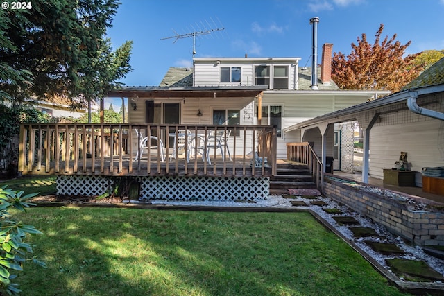 rear view of house with a wooden deck and a yard