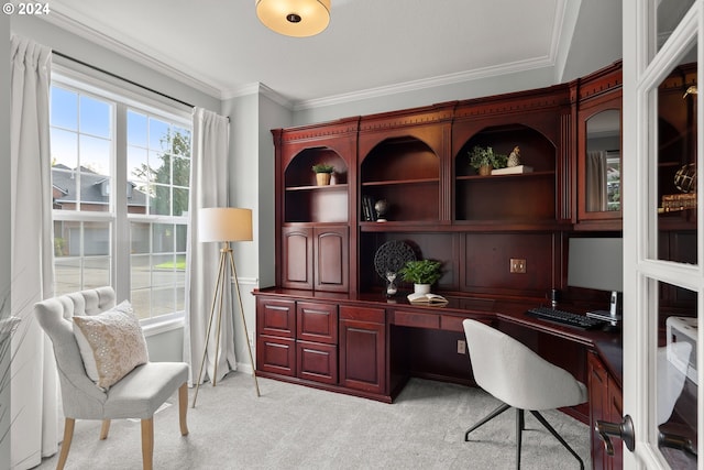 carpeted office with built in desk and ornamental molding