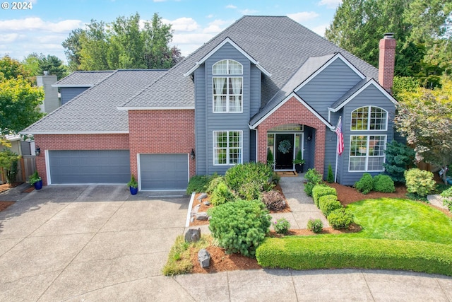 view of front property with a front lawn and a garage