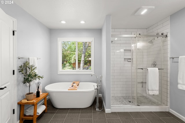 bathroom featuring separate shower and tub