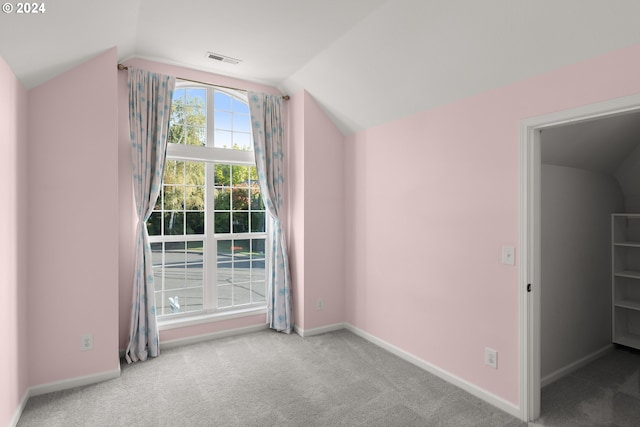 bonus room featuring light carpet and lofted ceiling