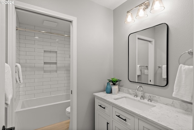 full bathroom featuring vanity, toilet, and tiled shower / bath combo