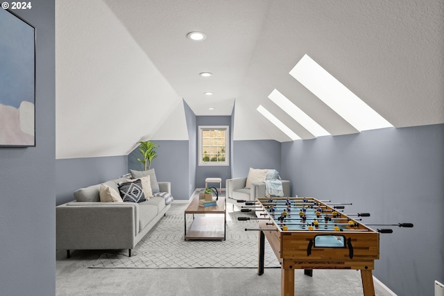 game room featuring lofted ceiling with skylight and carpet