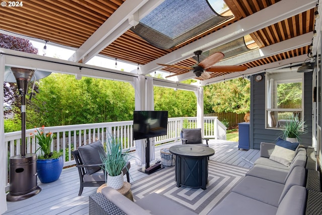 deck featuring ceiling fan and outdoor lounge area