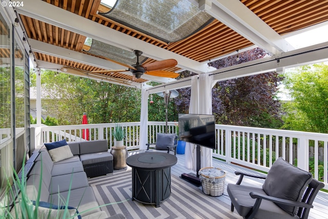 wooden terrace with outdoor lounge area and ceiling fan