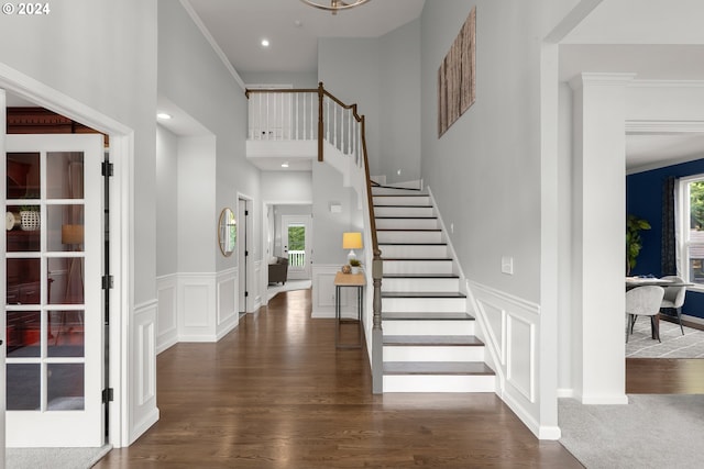 entrance foyer with crown molding, dark hardwood / wood-style flooring, and plenty of natural light