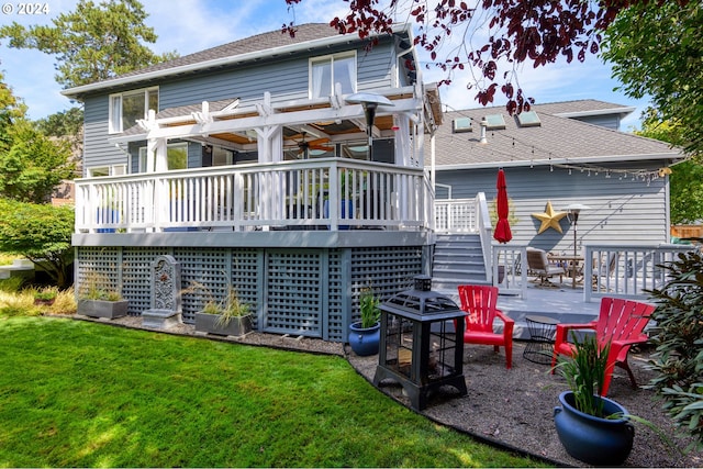 back of house with a pergola, a wooden deck, and a yard