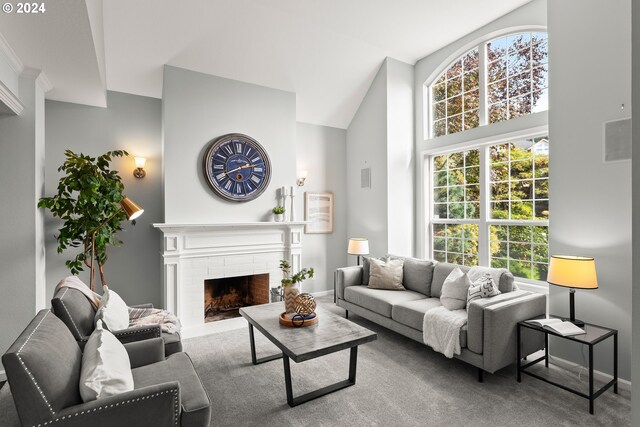 living room featuring lofted ceiling, carpet floors, and a brick fireplace