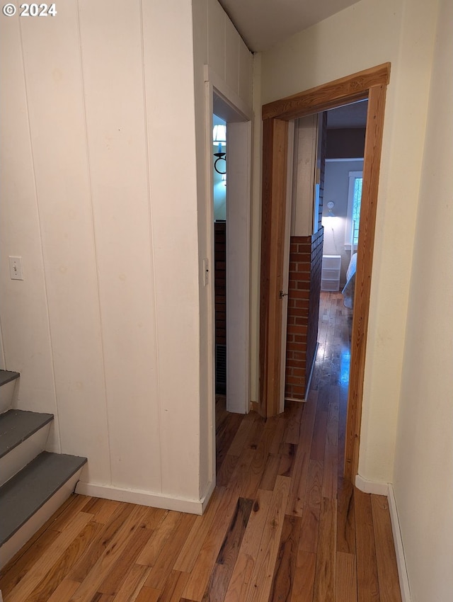 hall with hardwood / wood-style floors