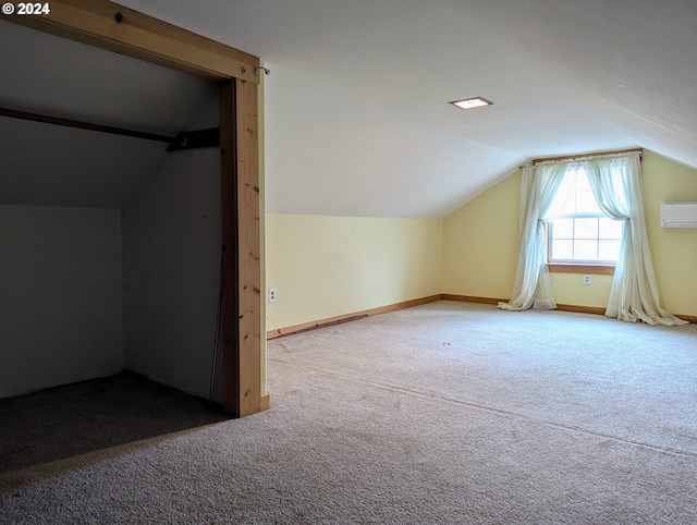 bonus room with carpet flooring, lofted ceiling, and a wall mounted air conditioner