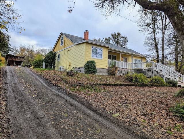 view of front of house with a porch and central AC