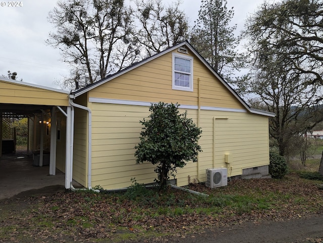 view of property exterior with ac unit and a carport