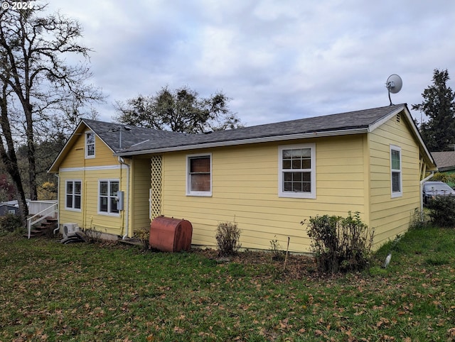 back of house with a lawn