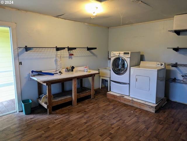 laundry area with dark wood-type flooring and washer and dryer