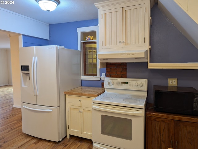 kitchen featuring white appliances and light hardwood / wood-style floors