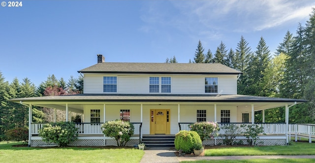 farmhouse with a porch and a front yard