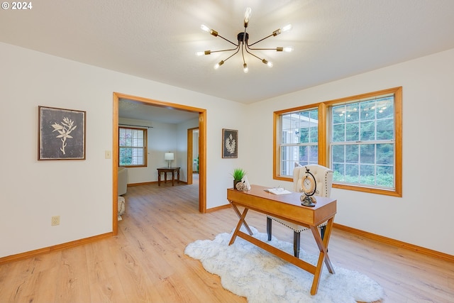 office space featuring a chandelier and light hardwood / wood-style flooring