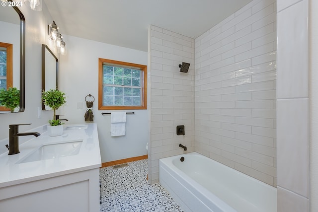 full bathroom featuring tiled shower / bath combo, vanity, and toilet