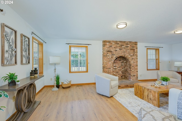 living room with a textured ceiling and light wood-type flooring