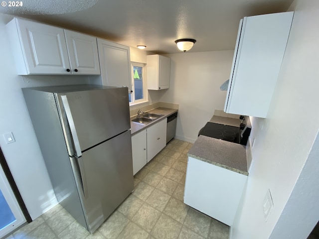 kitchen with ventilation hood, white cabinetry, appliances with stainless steel finishes, and sink