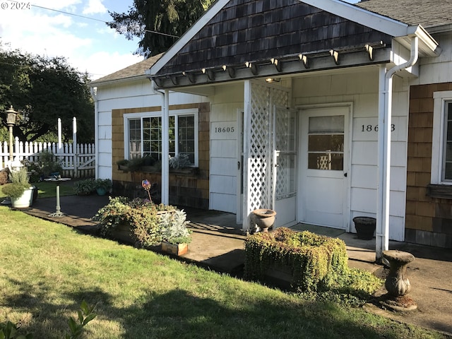 entrance to property with a yard