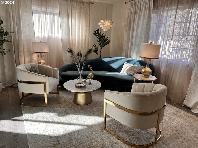 sitting room with a notable chandelier and carpet floors