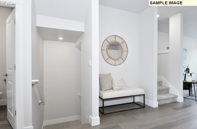 hallway with hardwood / wood-style floors