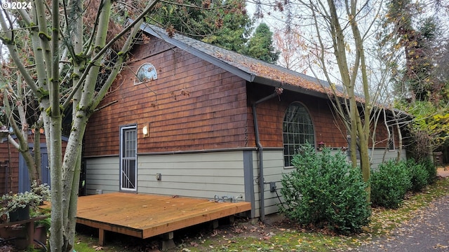 view of side of home featuring a wooden deck