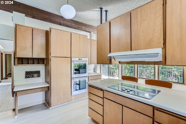 kitchen with pendant lighting, black electric stovetop, light hardwood / wood-style floors, a textured ceiling, and double oven