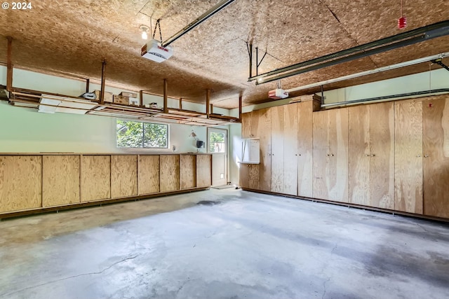 garage with a garage door opener and wooden walls