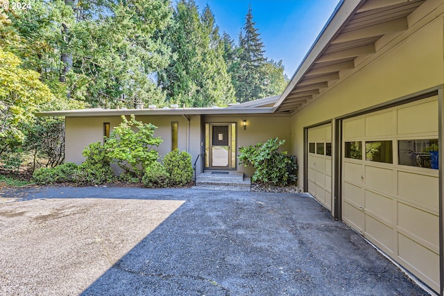 doorway to property featuring a garage