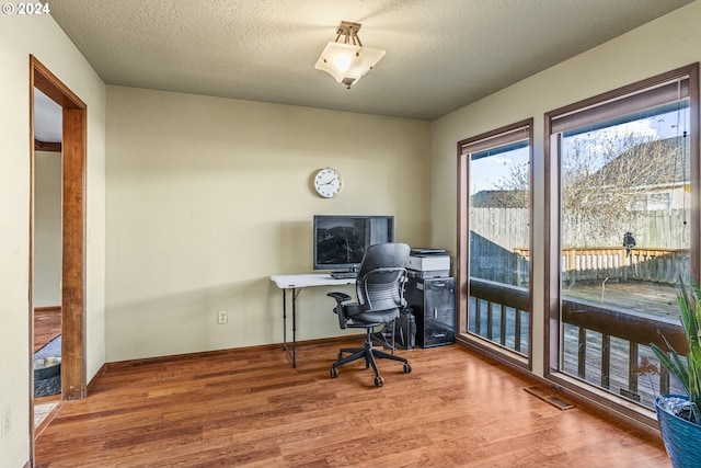 office featuring hardwood / wood-style floors and a textured ceiling