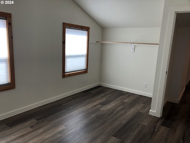 unfurnished bedroom with lofted ceiling, dark wood-type flooring, and a closet