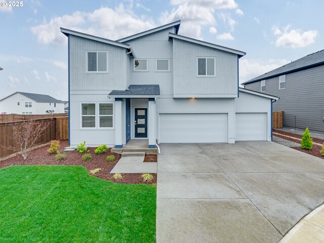 view of front of property with a garage and a front lawn