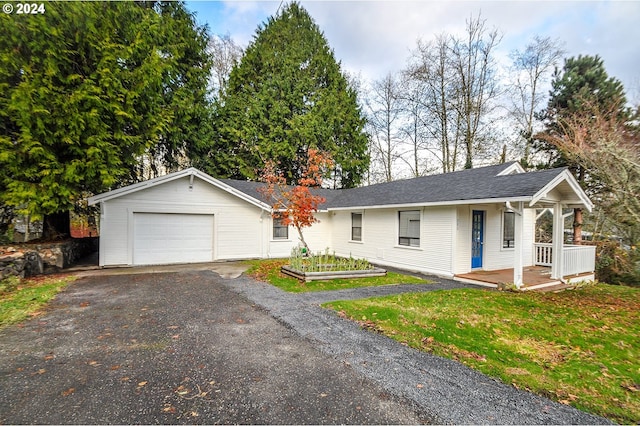 single story home featuring a garage and a front lawn