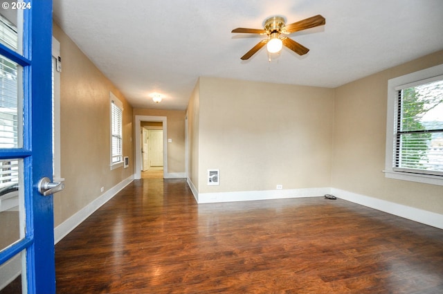 unfurnished room with dark hardwood / wood-style floors and ceiling fan