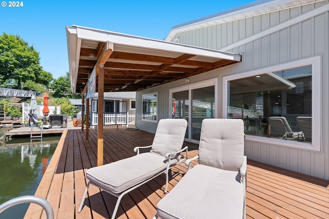 wooden terrace featuring a water view and a dock