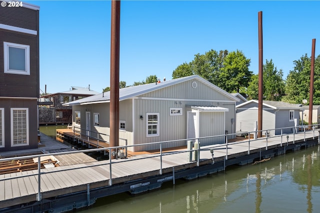 back of property featuring a water view