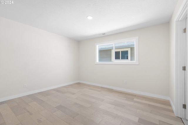 spare room featuring light hardwood / wood-style flooring