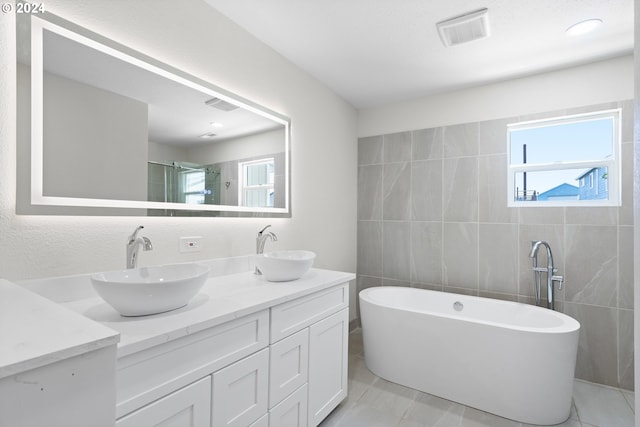 bathroom featuring tile patterned flooring, plenty of natural light, and vanity