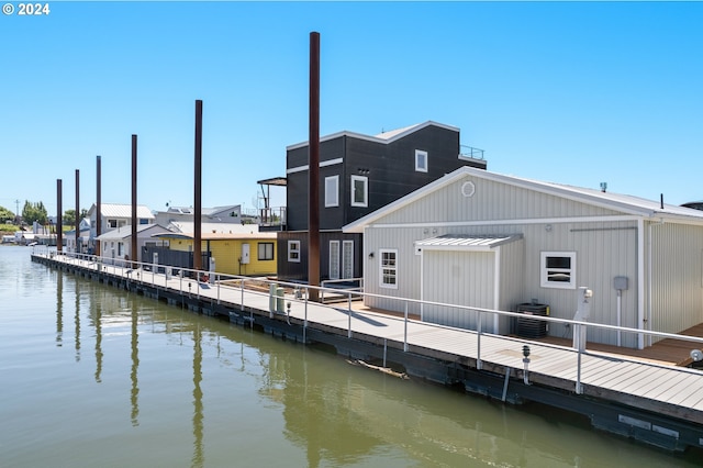 dock area with central AC and a water view