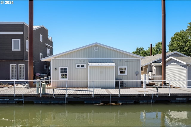 back of property featuring a water view