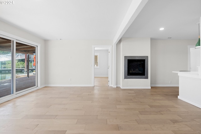 unfurnished living room featuring light hardwood / wood-style floors