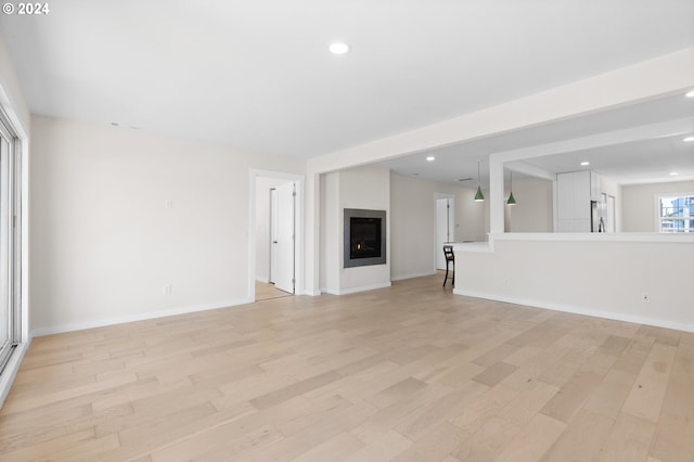 unfurnished living room featuring light wood-type flooring