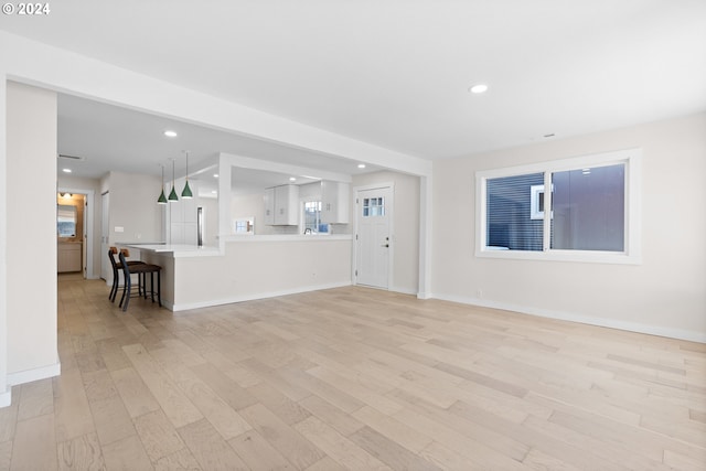 unfurnished living room featuring light hardwood / wood-style floors