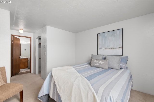 carpeted bedroom featuring connected bathroom