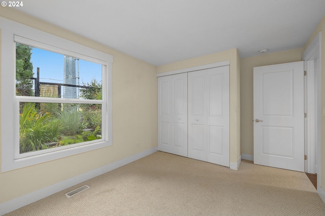 unfurnished bedroom with carpet floors and a closet